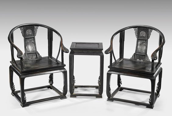 PAIR CARVED ZITAN HORSESHOE-BACK CHAIRS: PAIR CARVED ZITAN HORSESHOE-BACK CHAIRS Pair of Chinese zitan wood, horseshoe-back armchairs, on bowed legs upon stretch supports; with openwork scrolled motif flanges; and with matching side table; H