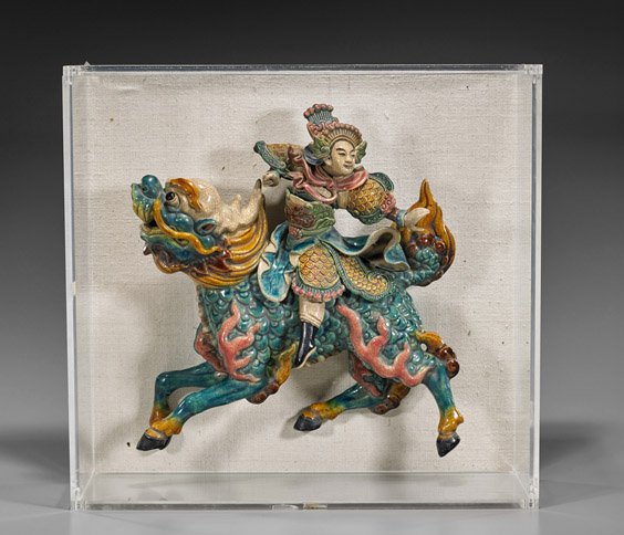 Old Chinese Glazed Pottery Roof Tile: Old Chinese Glazed Pottery Roof Tile Old Chinese glazed pottery roof tile; of an elaborately dressed soldier riding upon a prancing qilin (fine crackle, minor wear); H: 15"; lucite frame