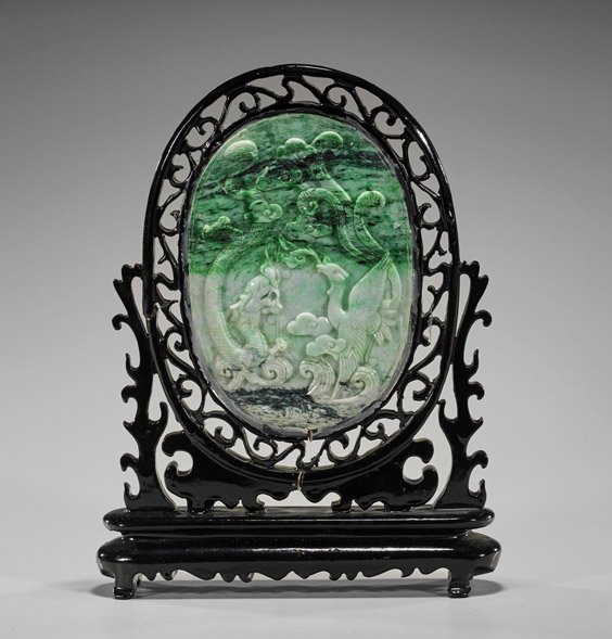 Chinese Carved Jadeite Oval Tablescreen: Chinese Carved Jadeite Oval Tablescreen Chinese carved jadeite tablescreen; oval form, with relief design of a dragon and phoenix above waves to front; cranes in a landscape with pine and double gourd