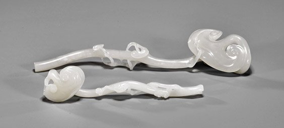 Two Mini Carved White Jade Ruyi Scepters: Two Mini Carved White Jade Ruyi Scepters Two miniature Chinese carved white jade Ruyi scepters; each of naturalistic form; each with cloudy inclusions; L: 9 1/2" (larger)