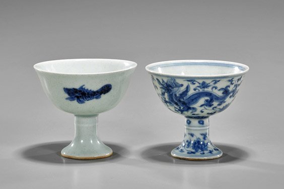 Two Ming-Style Porcelain Stem Cups: Two Ming-Style Porcelain Stem Cups Two small Chinese Ming-style blue and white porcelain stem cups: depicting sinuous dragons amid scrolling flowers; together with school of fish; 6-character mark to 