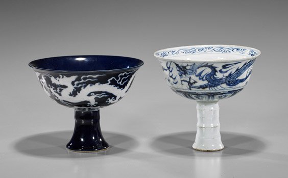 Two Chinese Porcelain Stem Cups: Two Chinese Porcelain Stem Cups Two Chinese porcelain stem cups, each depicting sinuous dragons: reverse blue and white, 6-character mark; together with Yuan-style blue and white incised interior and 