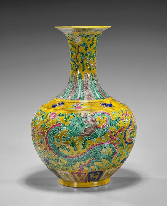 Chinese Moulded Porcelain Vase: Chinese Moulded Porcelain Vase Chinese moulded porcelain vase; of globular form with long waisted neck, phoenix and dragon design on yellow ground with floating Buddhist emblems at the shoulder, sligh