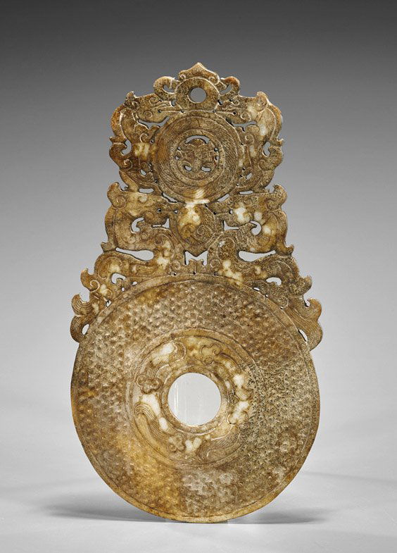 Carved Jade/Hardstone Bi Pendant: Carved Jade/Hardstone Bi PendantLarge archaistic Chinese carved jade or hardstone pendant; of bi form with fungus motifs to center; a smaller bi to the top flanked by sinuous dragons and foliate desig