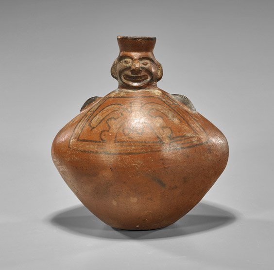 Pre-Columbian Nasca/Chimu Vessel: Pre-Columbian Nasca/Chimu VesselPeruvian Pre-Columbian (Nasca or Chimu) redware pottery vessel; of elongated spheroid form with faux handles to shoulder, the short neck depicting a human head with; pa