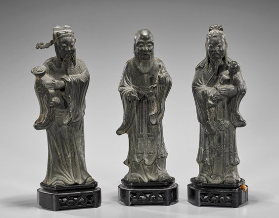 Three Ming Dynasty Bronze Star Gods: Three Ming Dynasty Bronze Star Gods Set of three Ming Dynasty bronze figures; of the Three Star Gods, Fu, Lu and Shoulao standing in heavy robes, each with their own attribute (repairs and minor losse