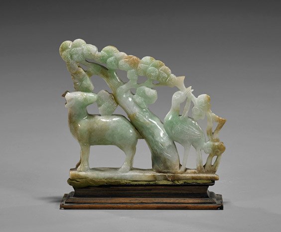 Carved Jadeite Deer & Crane Group: Carved Jadeite Deer & Crane Group Chinese Carved jadeite animal group; depicting a deer and crane beneath pine; of pale green coloration with russet infusions (minor losses and old repairs); L: 4 1/2"