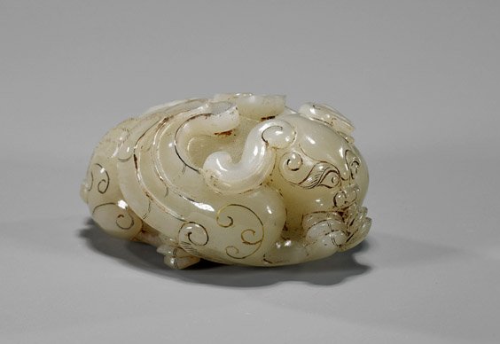 Archaistic Chinese Carved Grey Jade Hydra: Archaistic Chinese Carved Grey Jade Hydra Archaistic Chinese carved grey jade hydra; recumbent with wings pulled close to the body and forked tail curved beneath the haunches, scrolling gilt detail th