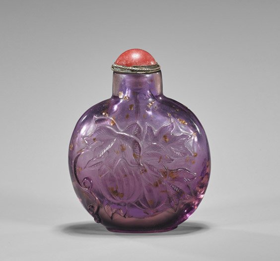 Carved Beijing Glass Snuff Bottle: Carved Beijing Glass Snuff Bottle Finely hollowed, carved Beijing glass snuff bottle; of flattened circular form depicting a squirrel eating grapes to front, auspicious gourds to verso; lavender color