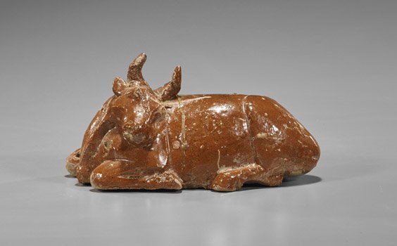 Rare Han Dynasty Brown Glazed Bull: Rare Han Dynasty Brown Glazed Bull Rare and moulded, Chinese Han Dynasty brown glazed pottery model; of a recumbent bull (typical glaze flaws but great condition); L: 7"