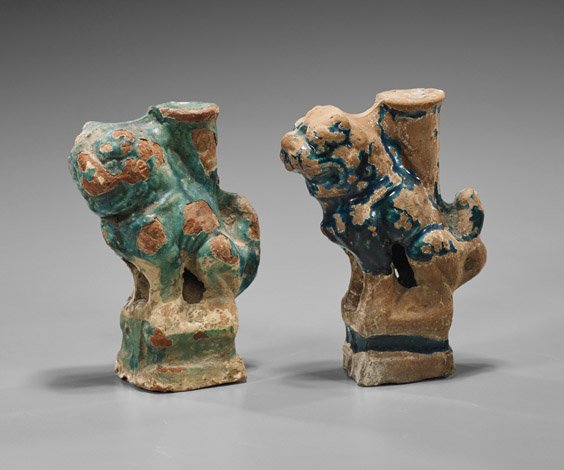 Pair Antique Glazed Pottery Lions: Pair Antique Glazed Pottery Lions Pair of antique Chinese glazed pottery lions; each seated upon a square base, bearing teeth with candle holder moulded to back, some original pigment remaining (as-is