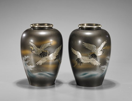 Pair Old Japanese Bronze Vases: Pair Old Japanese Bronze VasesPair of old, Japanese bronze vases; of ovoid form with a rolled lip, depicting gilt and silvered flying cranes above rough waves; H: 8 1/2" (each)