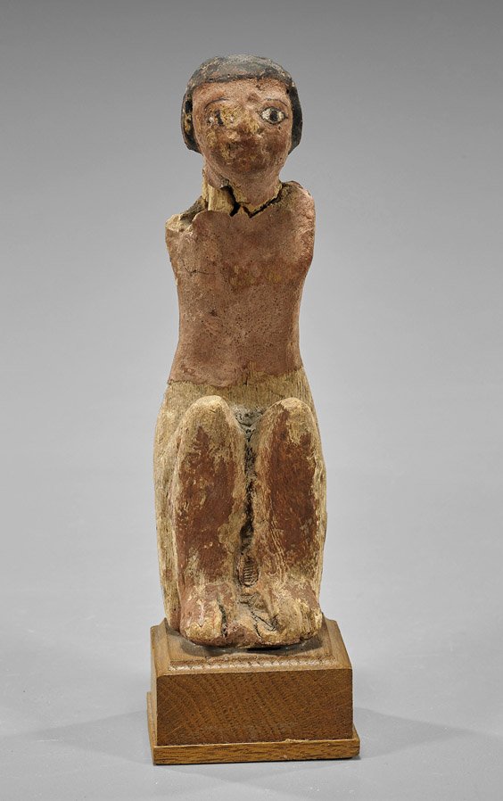 Egyptian Gesso-Painted Wood Boatman: Egyptian Gesso-Painted Wood Boatman Ancient Egyptian gesso-painted and carved wood boatman; seated with knees close to body, hair and facial features in black with white highlights, his skin painted r