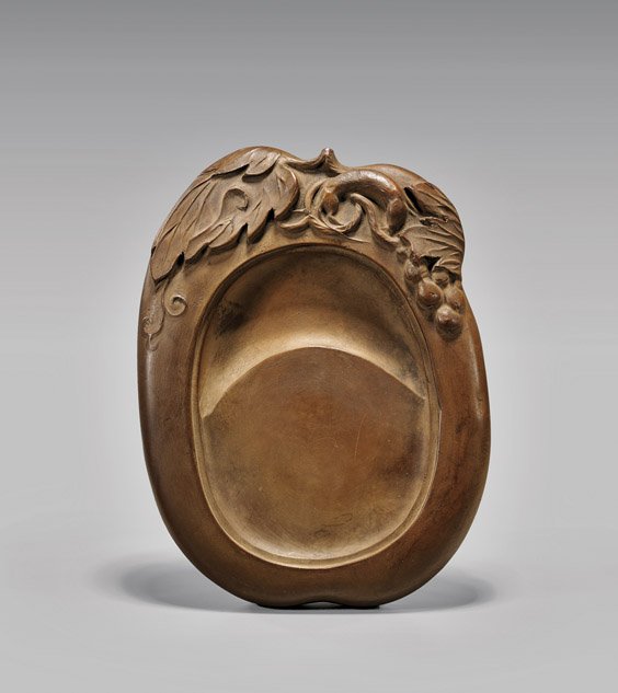 CHINESE YIXING CERAMIC INKSTONE: CHINESE YIXING CERAMIC INKSTONE Chinese yixing ceramic inkstone; of freeform, the top with a squirrel curled amid the foliage and gourds in relief; L: 7 1/2"