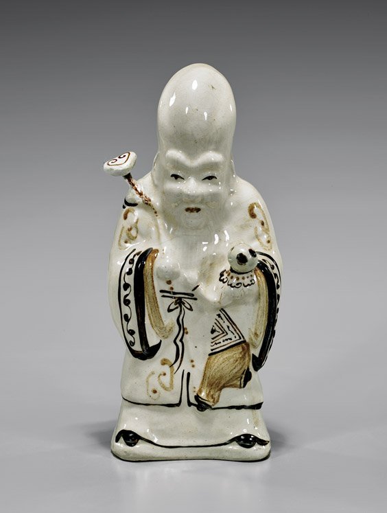 CHINESE CIZHOU PORCELAIN SHOULAO: CHINESE CIZHOU PORCELAIN SHOULAOChinese cizhou glazed porcelain figure; of Shoulao standing in sparsely decorated robes, holding a scepter and a pearl; possibly Yuan Dynasty; H: 11 3/4"; Provenance: F