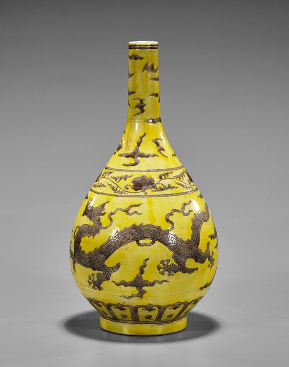 Chinese Yellow Ground Bottle Vase: Chinese Yellow Ground Bottle VaseChinese yelloe ground porcelain bottle vase; with aubergine contestign dragons amid celestial field; 6-character mark; H: 10"
