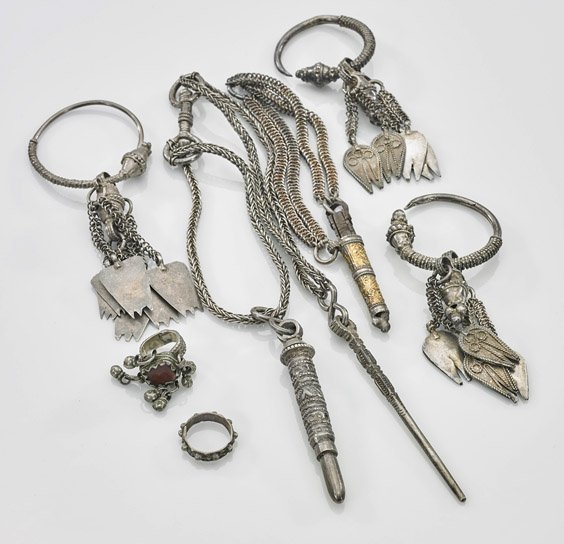 Seven Antique Omani Silver Jewelry: Seven Antique Omani Silver Jewelry Seven antique Omani silver jewelry: two finger-rings, one with charms and carnelian stone; three C-shaped hoop earrings (halqa or hilqa), each decorated with removab