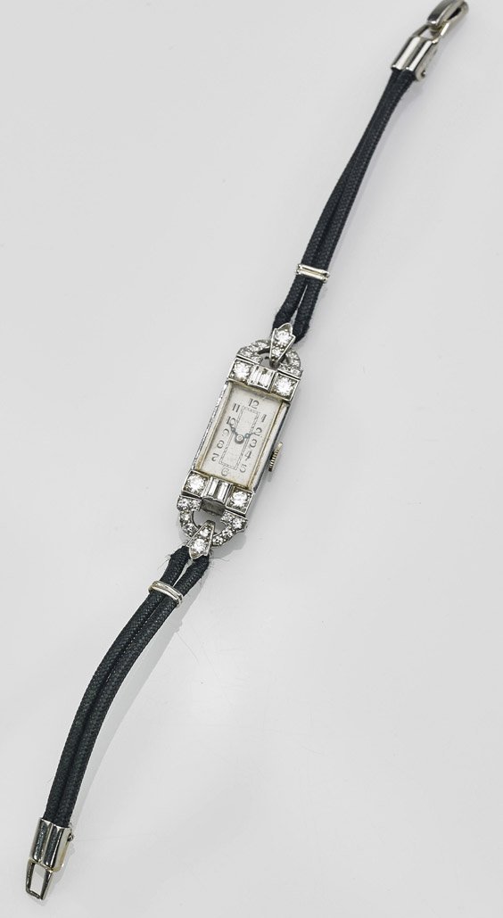 Ladies' Art Deco 18K Gold & Diamond Watch: Ladies' Art Deco 18K Gold & Diamond Watch Ladies' Art Deco 18K white gold wristwatch; of slim rectangular form, bordered by small round and baguette diamonds; Arabic numeral face; inscribed 'ANN' to v