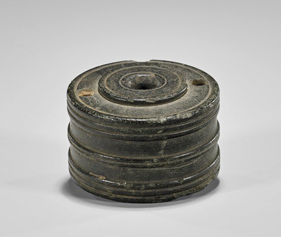 Bronze Circular Oil Lamp: Bronze Circular Oil Lamp Possibly Byzantine, bronze oil lamp; of cylindrical form with three holes to top, several concentric bands along body (chip to foot, typical wear); H: 1 3/4"