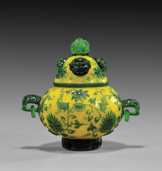 Chinese Carved Beijing Overlay Glass Vessel: Chinese Carved Beijing Overlay Glass Vessel Unusual Chinese carved Beijing glass covered vessel: of globular form with mask and loose ring handles, and with Buddhist florals, masks, and emblems; in br