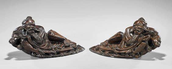 Pair Chinese Carved Wood Sages: Pair Chinese Carved Wood Sages Pair of Chinese carved wood sages; each reclining with their robes draped around them; L: 16" (each)