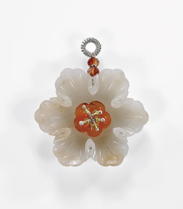 ANTIQUE WHITE JADE FLOWER PENDANT: Antique Chinese carved white jade floral form pendant; of six petaled chrysanthemum form, with a carnelian center and accented with seed pearls; D: 2 3/16"