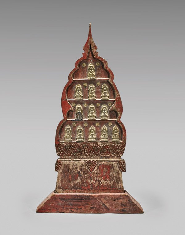 ANTIQUE CARVED BUDDHIST SHRINE PLAQUE: Antique carved and red painted Buddhist shrine plaque; of with pointed finial form, depicting twelve Buddhas in relief, above a lappet border, and set on a splayed base; Provenance: Estate of Garry Sh