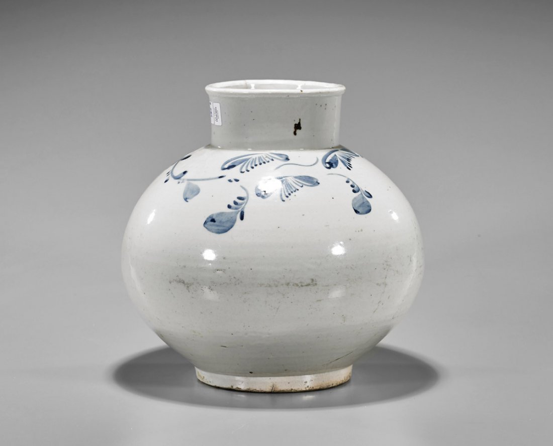 Antique Korean Blue & White Porcelain Jar: Antique Korean Choson dynasty blue and white porcelain jar; of globular form, with raised base and cylindrical neck; the exterior decorated with sparse, scrolling foliate design; 19th Century; H: 10&#