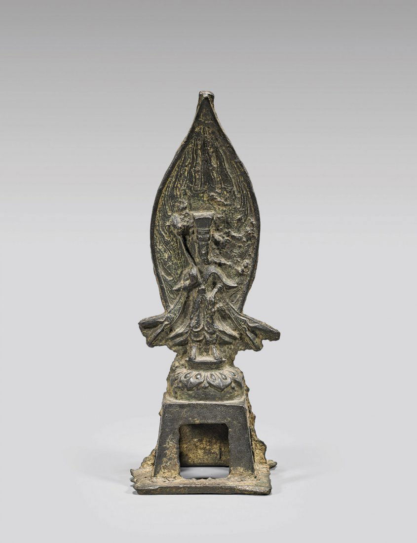 ANTIQUE CHINESE SUI-STYLE BRONZE FIGURE: Antique Chinese Sui Dynasty-style, bronze figure; of a deity in widely flared robes, with a teardrop-shape flaming mandorla, standing on a lotus base upon raised pedestal base; H: 6 3/4"
