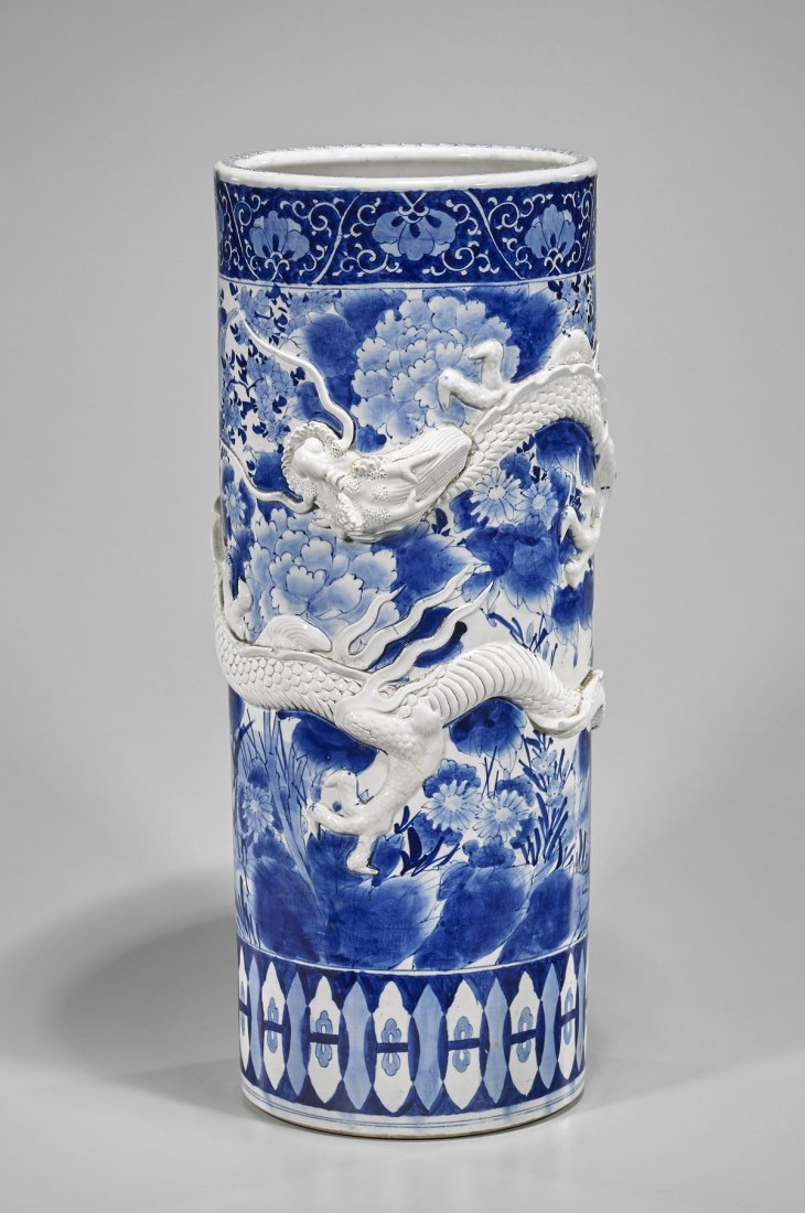 Old Chinese Blue & White Porcelain Umbrella Stand: Tall and old, Chinese blue and white porcelain umbrella stand; with elaborately moulded dragon wrapping around the middle; H: 24 1/2"