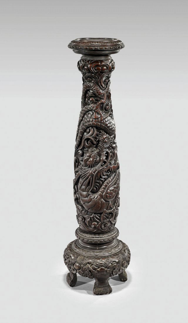 Tall Japanese Carved Hardwood Dragon Pedestal: Tall Japanese sectional hardwood pedestal; of tall, somewhat ovoid form, set upon four feet; with elaborately carved dragon and stylized clouds in high relief; H: 49"