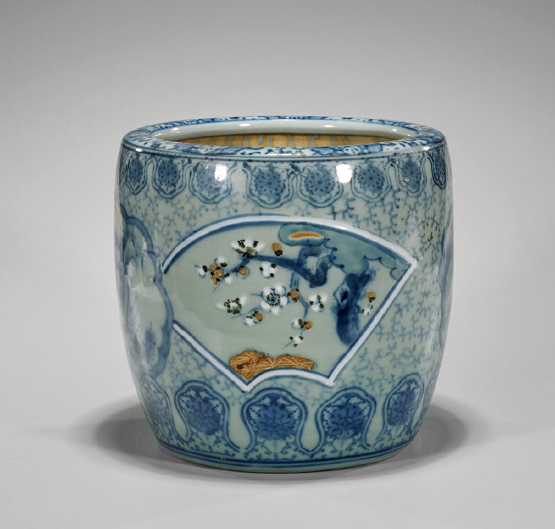 Old Japanese Porcelain Hibachi: Old Japanese porcelain hibachi; the cylindrical form with blue on celadon designs of cloud shaped landscape panels alternating with fan shaped blossoming branches; Provenance: From the Collection of E