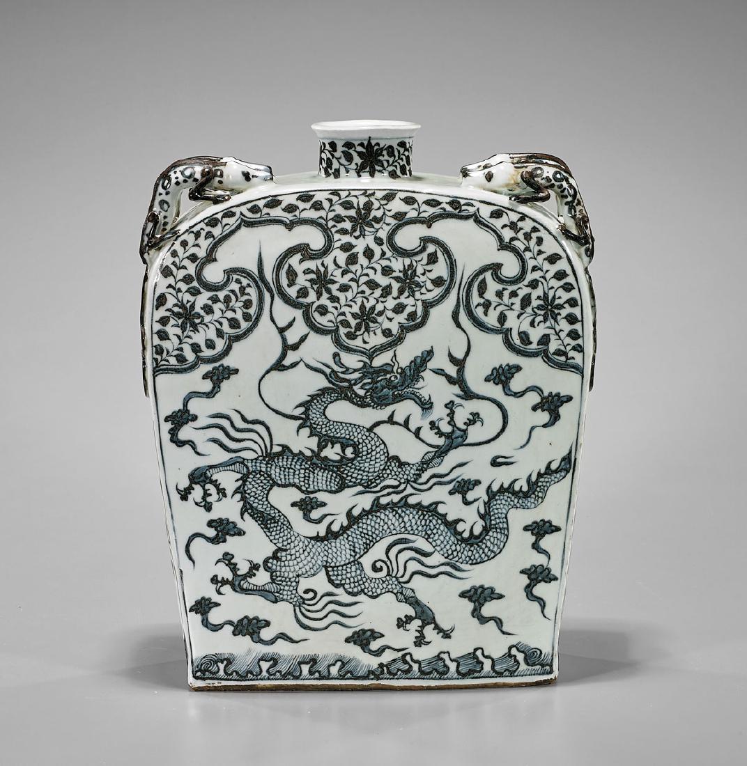 Large Yuan-Style Porcelain Flask: Large Yuan-style blue and white porcelain flask-form vase; each side with well-detailed central design of dragon writhing amid clouds; the curved shoulders with moulded lizard handles; H: 13 3/4"