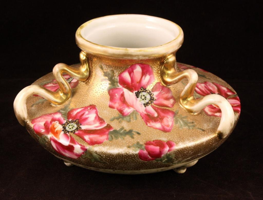 NIPPON Three-handled Vase with Red Floral Scene: Three-footed squat vase. 7" across and 4 1/4" tall. Gold beading. Mark #89. Excellent cond. with very heavy gold loss on top handles, rim & edges.