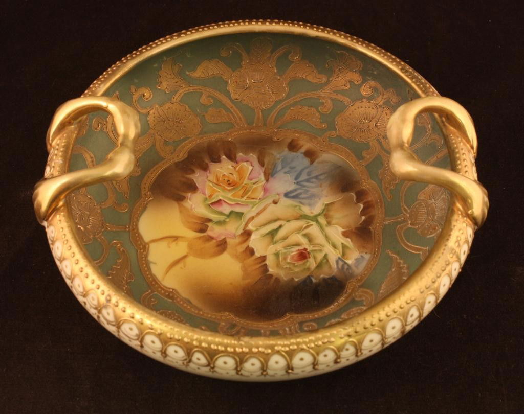 NIPPON Double Handled Bowl: 7" accross. Nice gold decoration with single window with roses in bottom of bowl on matted green background. Mark 52. Excellent condition with minor gold loss around rim and and handles.