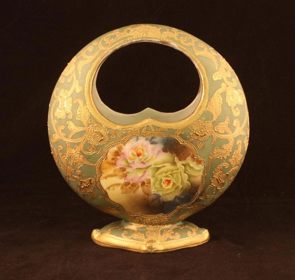 NIPPON Basket Vase: 8" tall and 7" accross. Window on front and back with roses on matted green background with beautiful gold accents. Mark 52. Excellent condition with very minor gold loss.