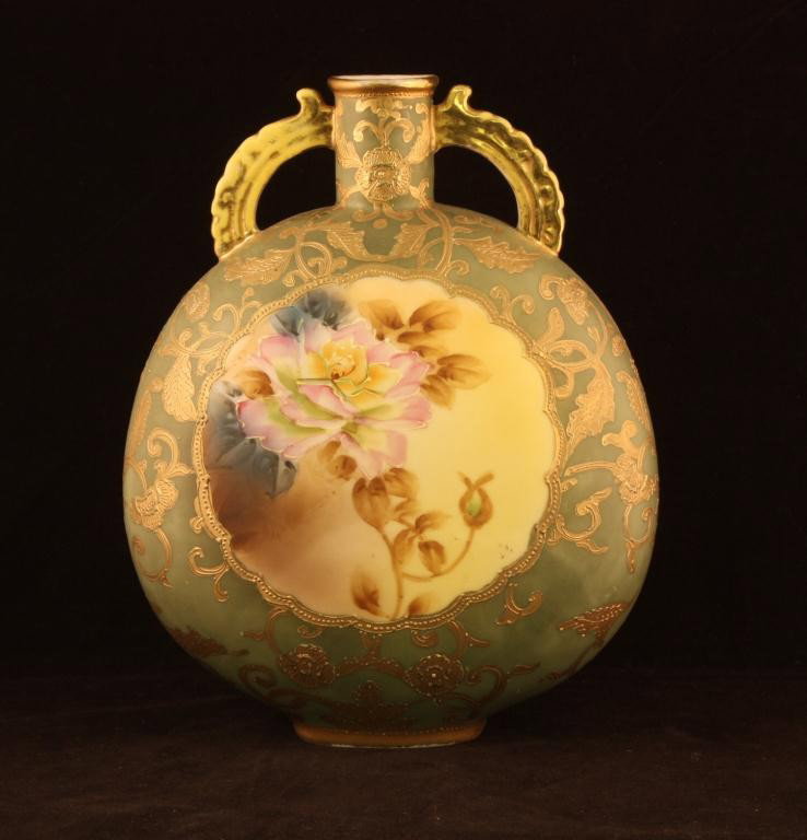 NIPPON Double Handled Vase: 9 1/2" tall and 7 1/2" accross. Large windows on front and back with roses on matted green background. Mark 52. Excellent condition with gold loss to handles and top of rim.