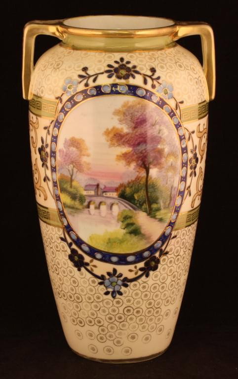 NIPPON Brideover River Scene Vase: 10 1/2" tall. Large window on front, smaller window scene of lake on back. Mark 47. Ex. cond. with gold loss to handles.