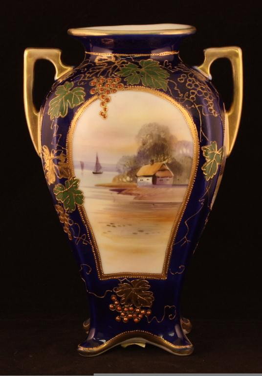 NIPPON Cobalt Lake Scene Vase: 9.75" with 4 window lake scenes including enameled grape decorations. Mark 47. Excellent condition with gold loss to handle and rim.