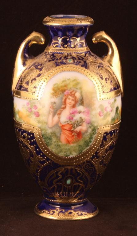 NIPPON Cobalt Portrait Vase of Woman with Flower: 7" tall. Gold scroll work and gold handles. Jeweled at top and bottom of portrait. Mark 52. Excellent condition with minor gold loss.