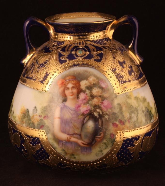 NIPPON Bulbous Cobalt Portrait Vase: 5 3/4" tall. Woman holding flowers. Green jewel at top of portrait. Mark 52. Excellent condition with gold loss to handles and rim.