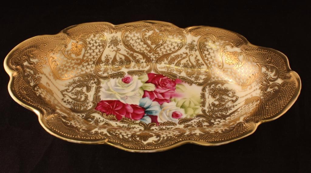 NIPPON Celery Dish: 11 1/2" Long. Red and White roses in center medallion. Extensive gold scroll decoration. Excellent condition with minor gold wear. Mark 52.