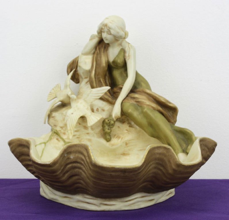 Royal Dux Art Nouveau Clam Bowl: with girl and pair of birds. Tip of wing of lower bird has been broken and glued on. 8 1/2" tall and 9 1/2" wide