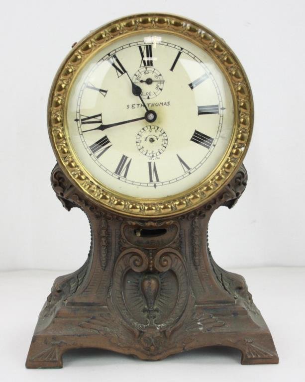 Seth Thomas Bronze Alarm Clock: Seth Thomas Bronze Alarm Clock. Hand painted face. Ornate base that depicts lions and owl. Alarm in working condition. 4 x 7 1/2 x 10 1/2