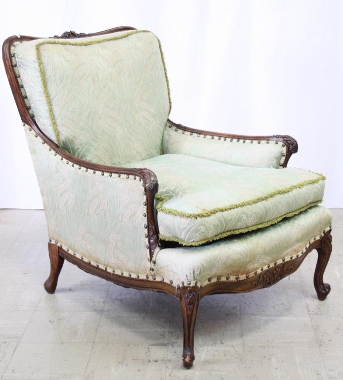 French Bergeres: Upholstered Parlor Chair Ornately Carved, Walnut Frame. Upholstery Has Nail Head Detail. 31 x 28 x 36