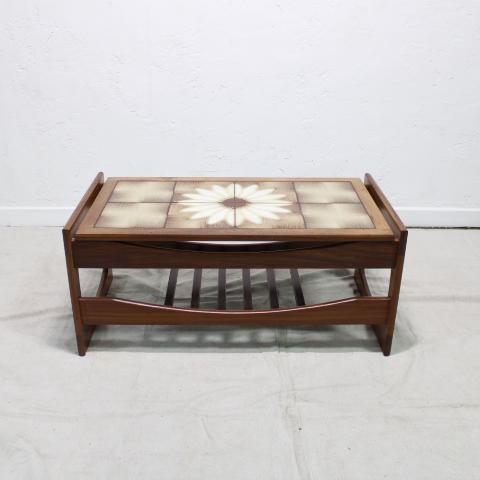 Mid Century Modern Tile Coffee Table: This Danish Modern style coffee table is from England, it features a floral (daisy) pattern in the tiles on top and a teak wood frame with open apron, a slatted shelf underneath and brass hardware on 