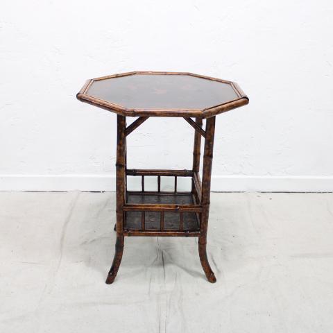 Octagonal Lacquered Bamboo Table: This British bamboo table features a lacquered Asian motif with birds and assorted florals, it has a shelf with a gallery on the bottom.