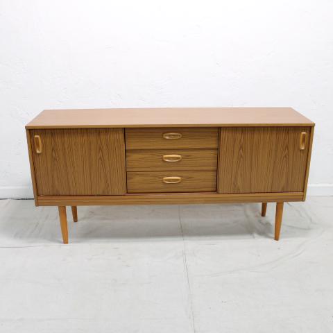 Mid Century Modern Sideboard by schreiber: This Danish Modern Style Sideboard is British and made by schreiber furniture co. It features two sliding doors & three drawers and is simulated teak.
