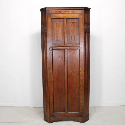 English Oak Corner robe: English single door corner cabinet, fitted on inside with various hooks and a shelf. Furniture Maker tag on inside, Locking door, has key.
