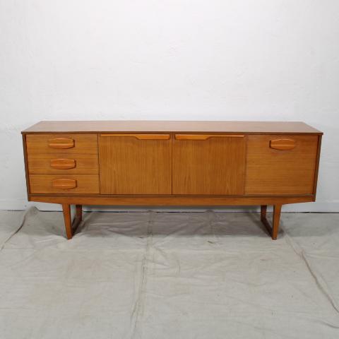 Teak Mid Century Modern Sideboard: This Danish Modern Style credenza is from England. It is on sleigh type legs, has 3 drawers, a double door storage area and a drop down cabinet.